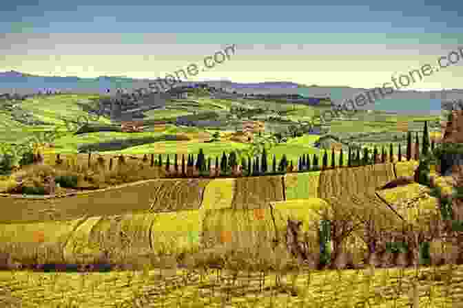 A Beautiful Landscape In Italy With Rolling Hills, Vineyards, And A Charming Village In The Distance. Two Years In Italy: How Two Fifty Somethings Retired And Went To Live In Italy To Live Cheap And Make Art